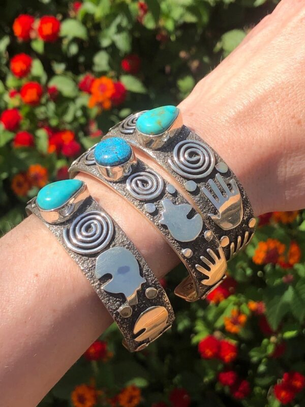 A pair of bracelets with blue stones on each side.