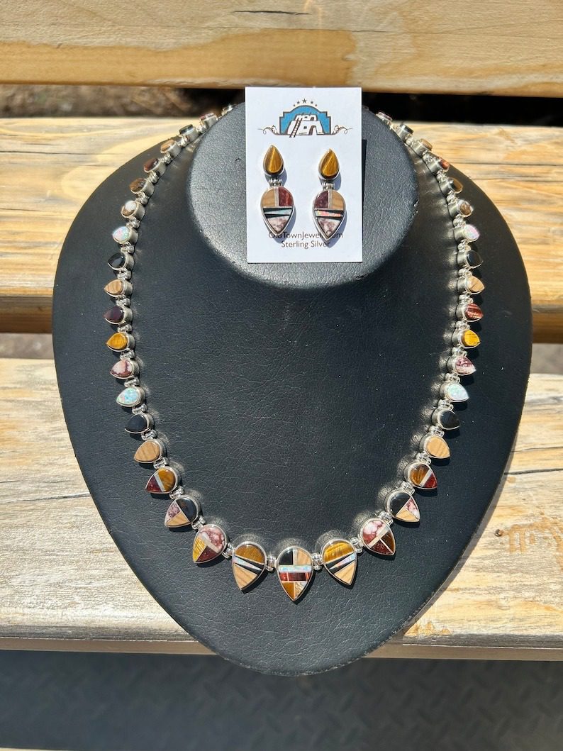 A necklace and earrings set on display.