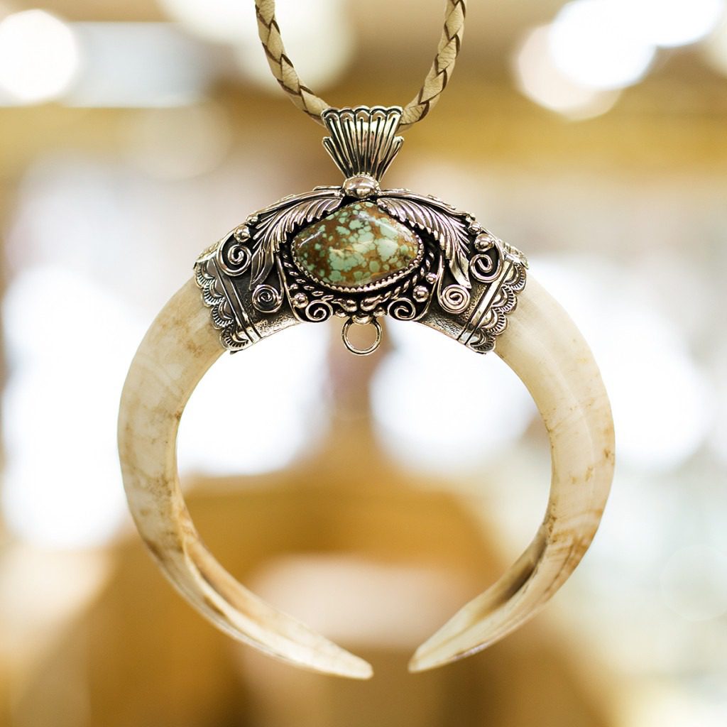 A necklace with a large horn on it