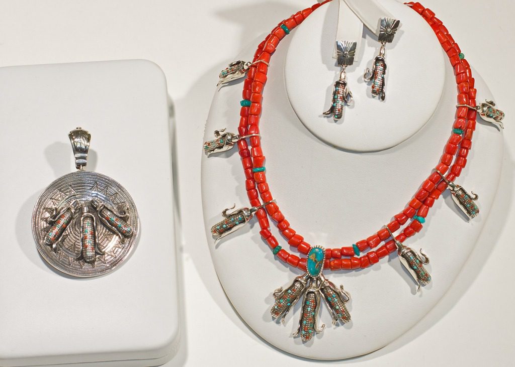 A necklace and earrings set with coral beads.