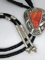 A silver and orange stone necklace with black leather