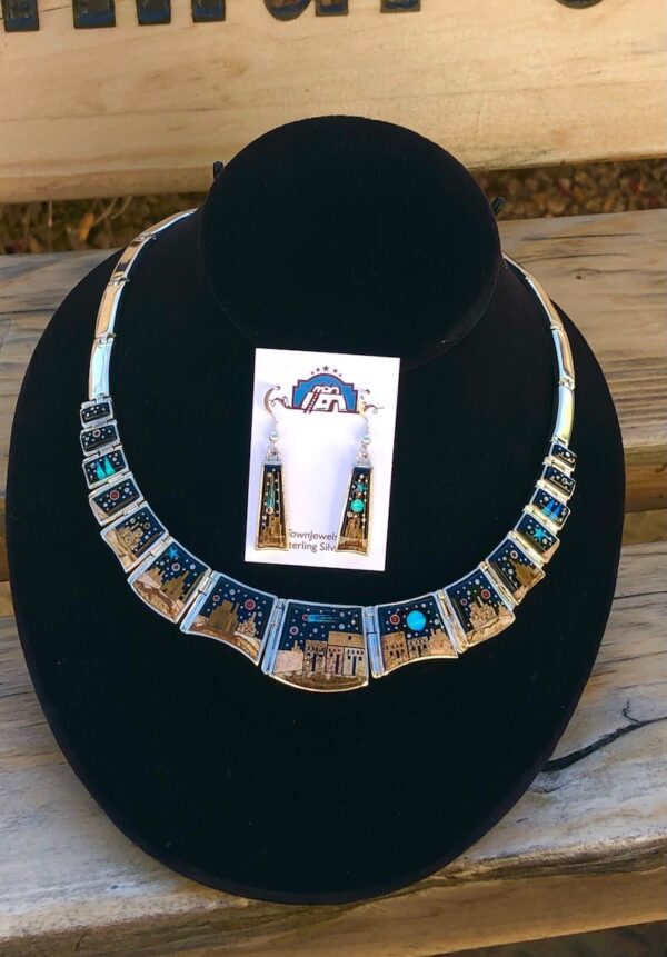 A necklace is shown on display in front of a card.