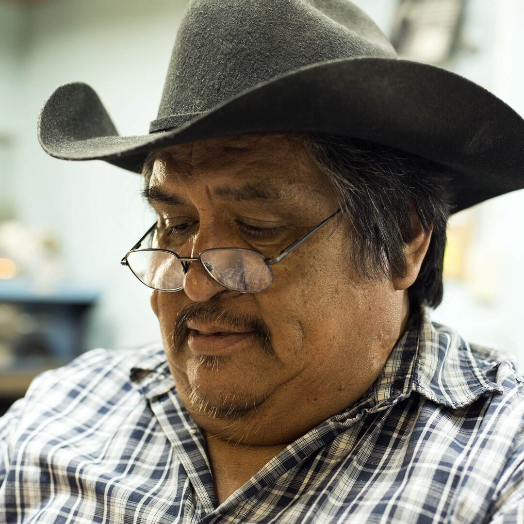 A man wearing glasses and a cowboy hat.