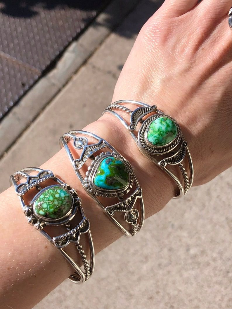 Three bracelets with different designs on them.