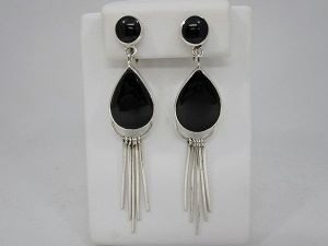 A pair of black and silver earrings hanging from the side.