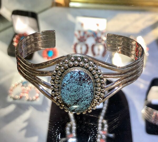 Cuff bracelet with oval turquoise stone.