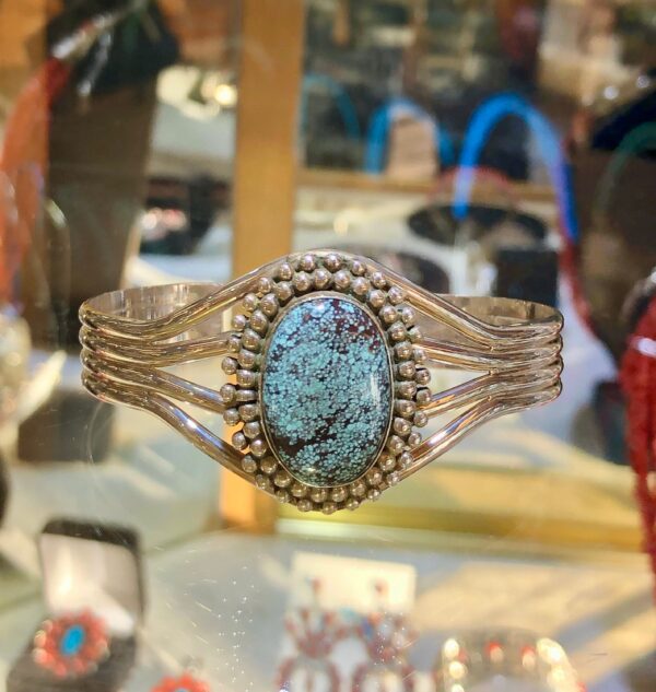 Cuff bracelet with oval turquoise stone.