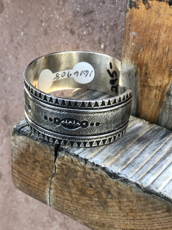 Vintage Navajo silver cuff bracelet with geometric design.