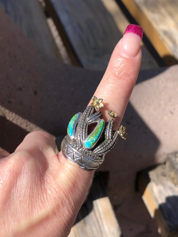 Cactus ring with green stones and gold flowers.