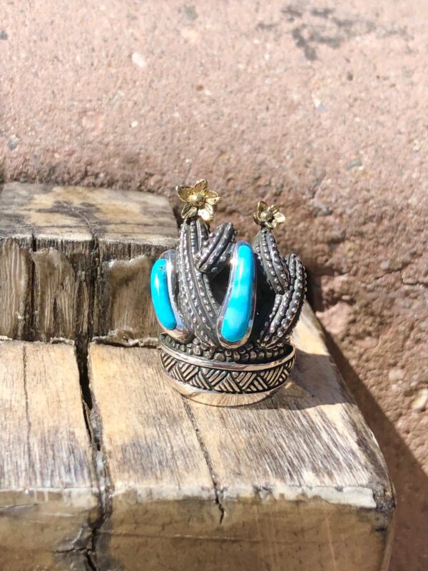 Cactus ring with blue stones and yellow flowers.