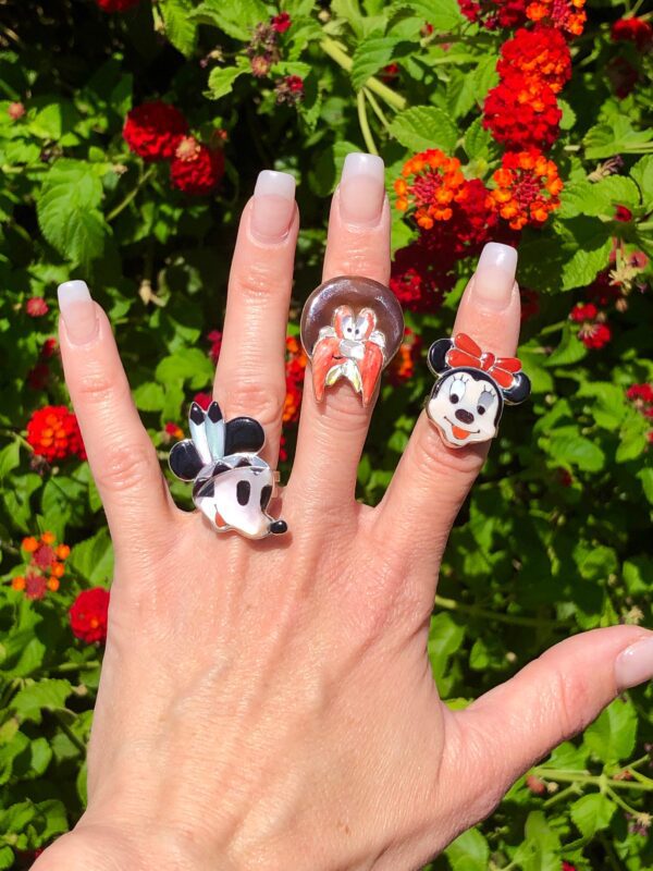 Three rings with Disney characters on them.