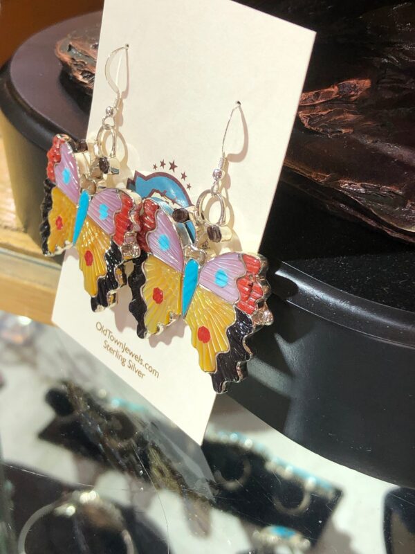 Colorful butterfly-shaped earrings with silver hooks.