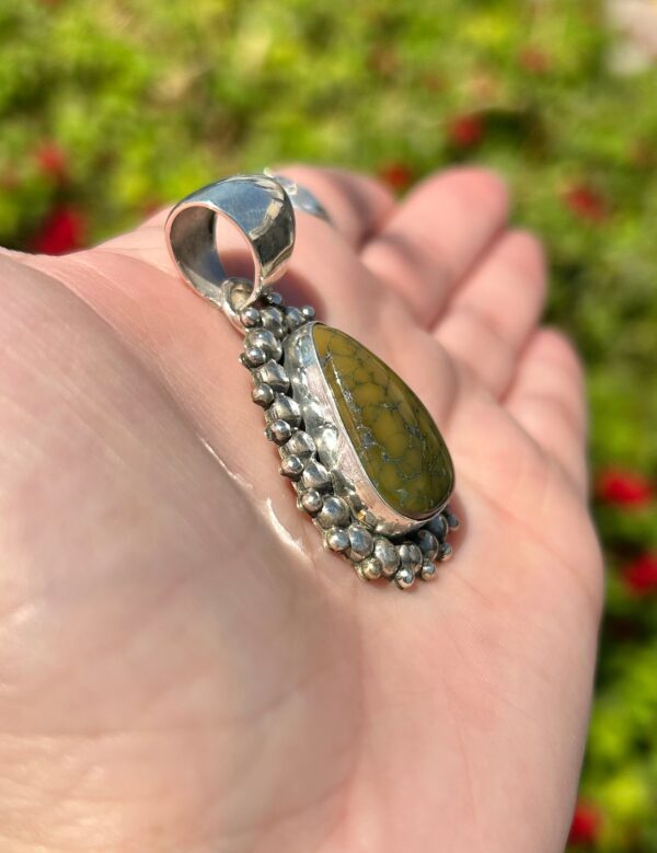 Sterling silver pendant with green stone.