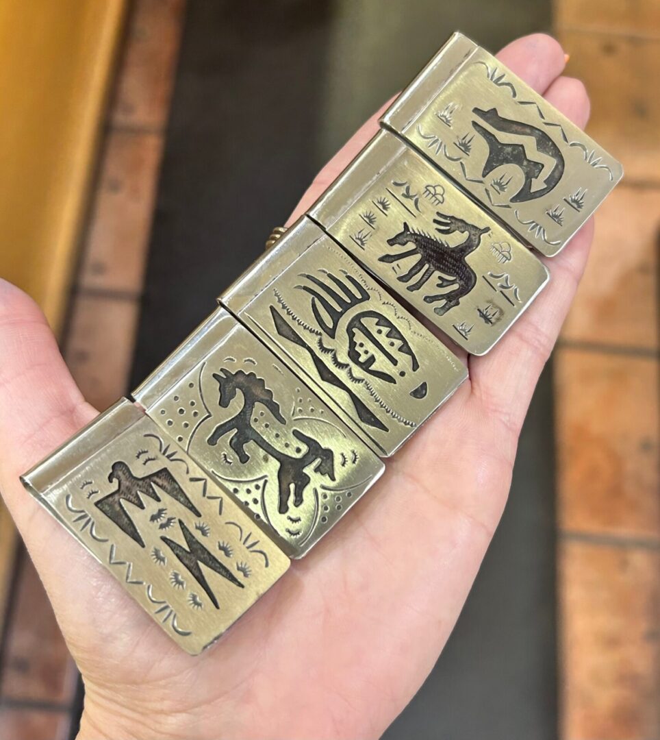 A person is holding a set of money clips.