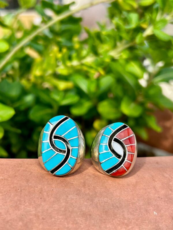 Two silver rings with colorful stone inlays.