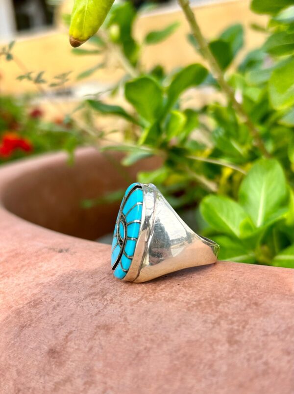 A silver ring with a blue stone inlay.