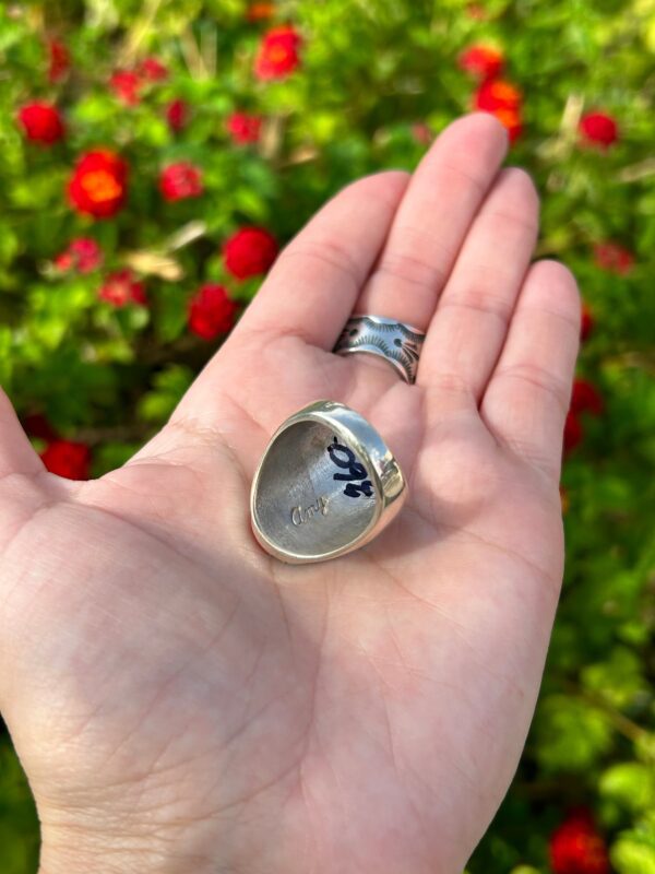 A silver ring with a flower design.