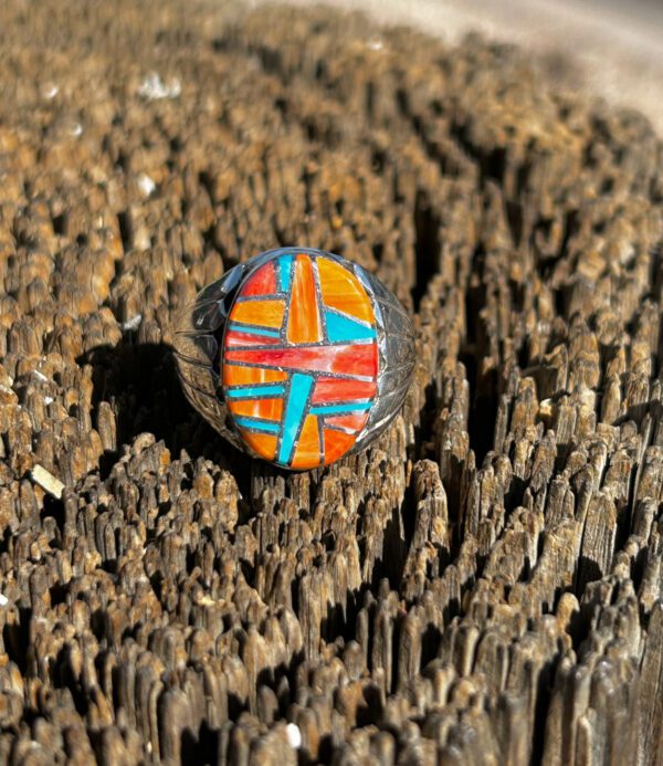 An oval-shaped ring with colorful stone inlay.