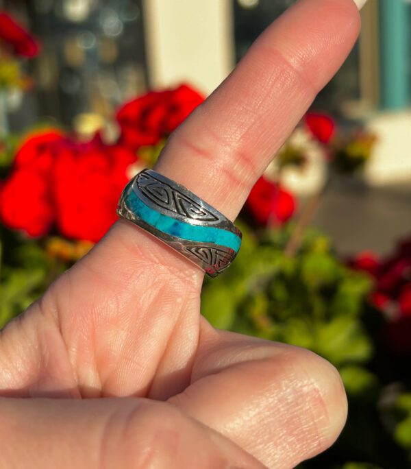 Celtic-style ring with blue stone inlay.