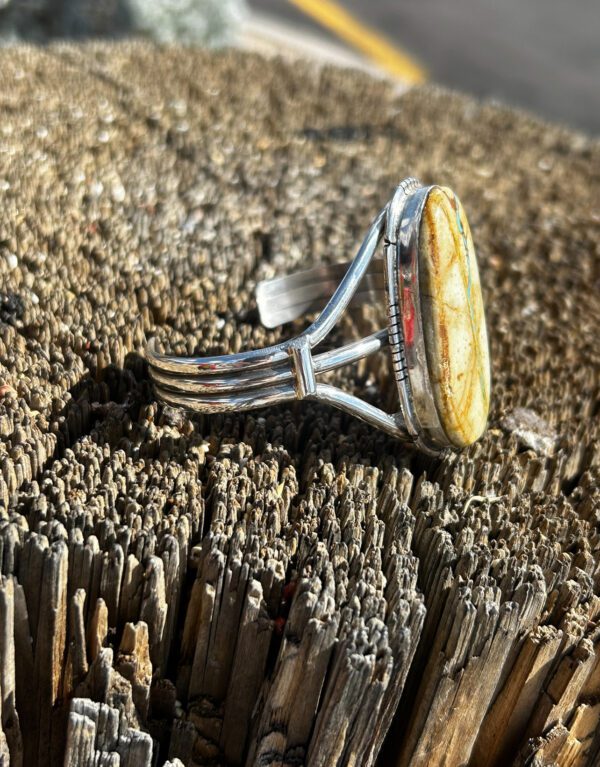 A silver and turquoise Native American cuff bracelet.