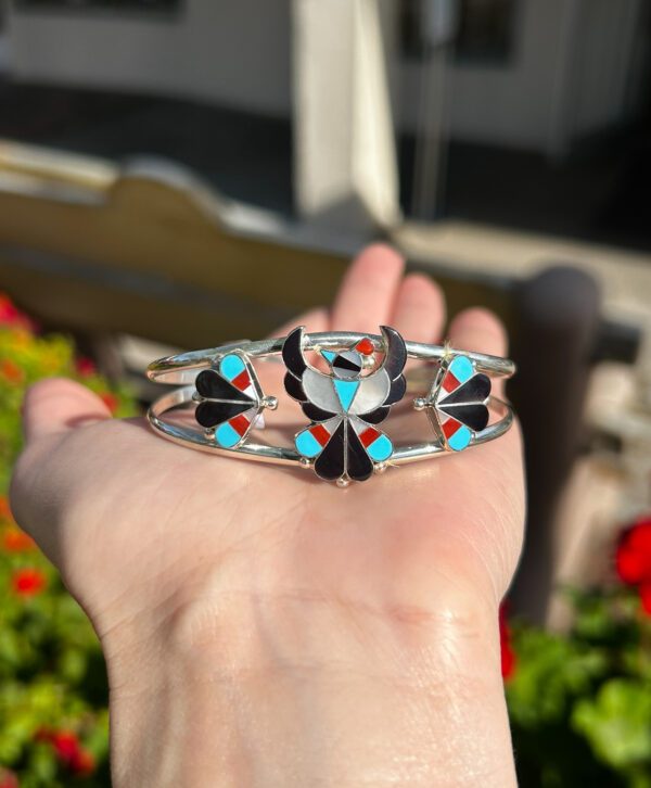 A silver bracelet with colorful Native American inlay.