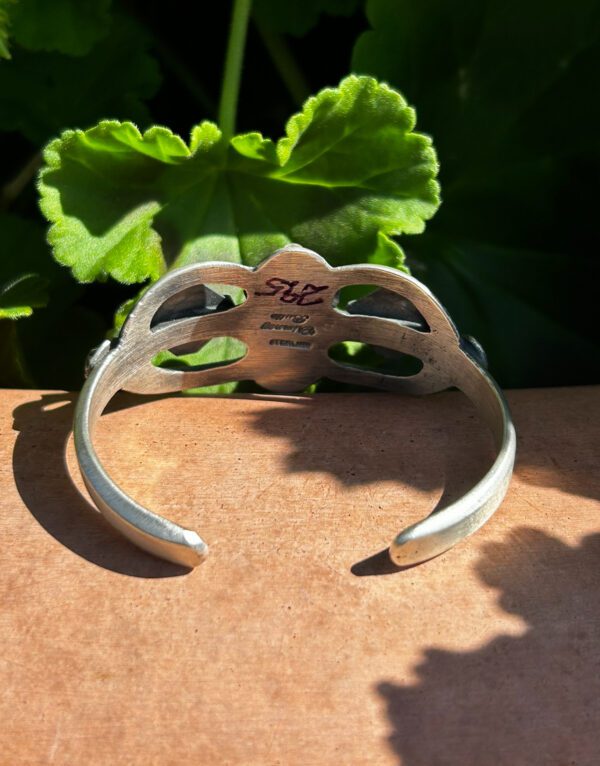 Vintage Navajo silver cuff bracelet with green patina.