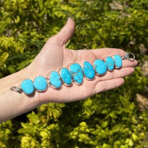 Turquoise and silver bracelet on hand.