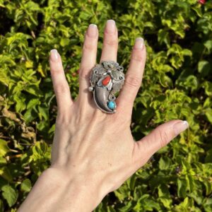 Silver ring with bear claw and stones.