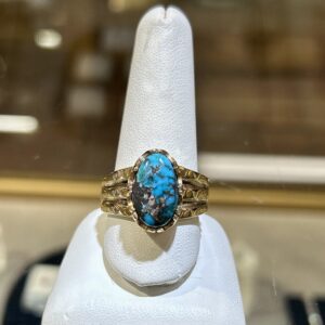 Gold ring with turquoise stone.