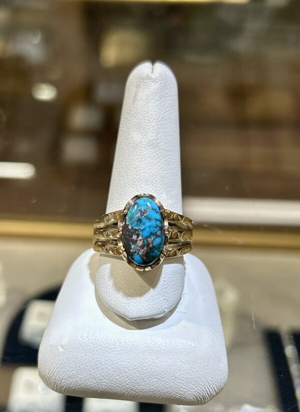 Gold ring with turquoise stone.