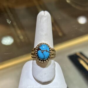 Gold ring with blue turquoise stone.