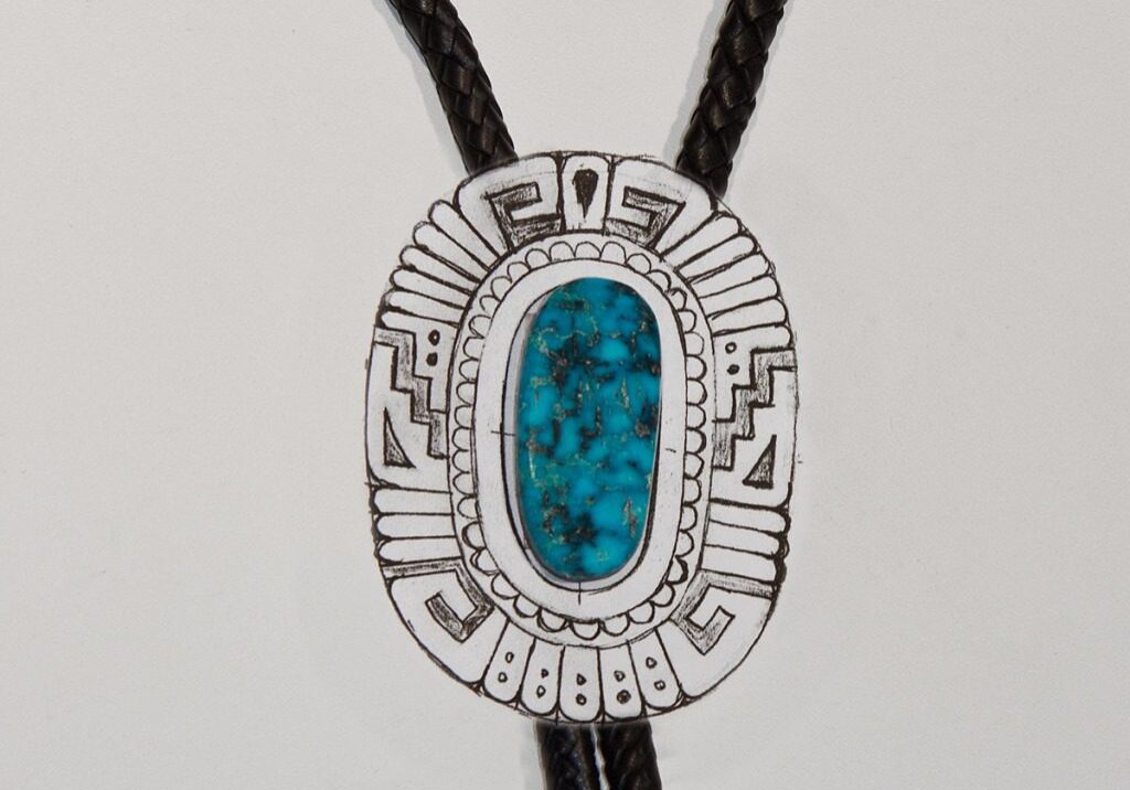 A silver and turquoise bolo tie with black cord.